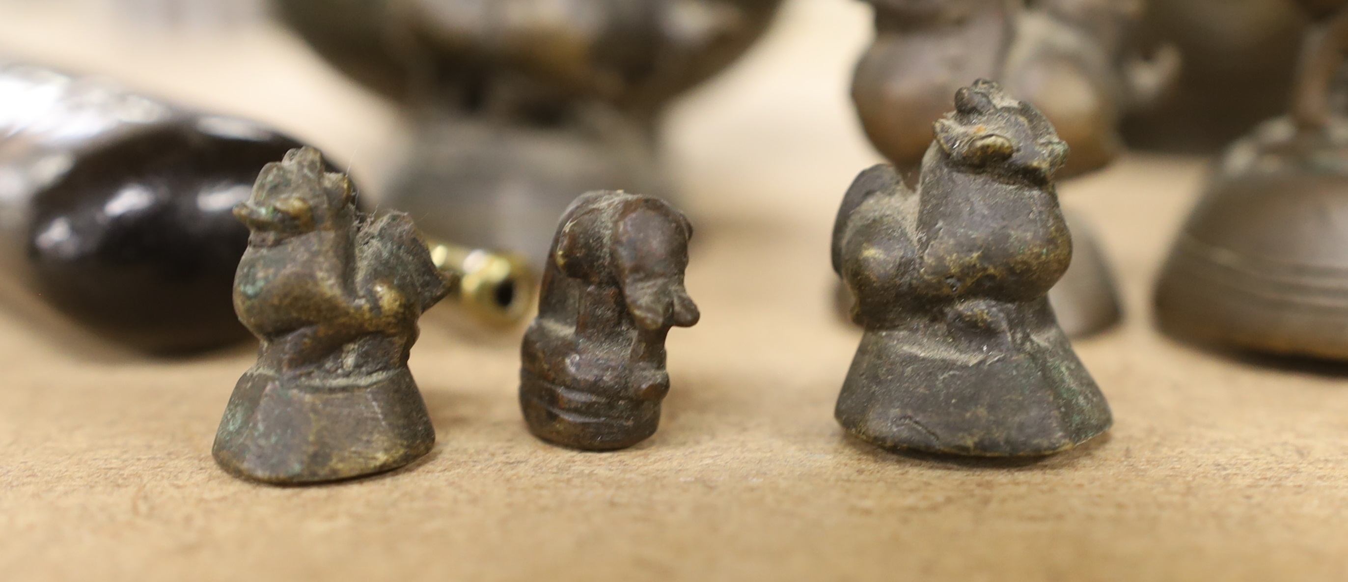 A set of Burmese bronze weights and a pair of bronze vases, 12cm